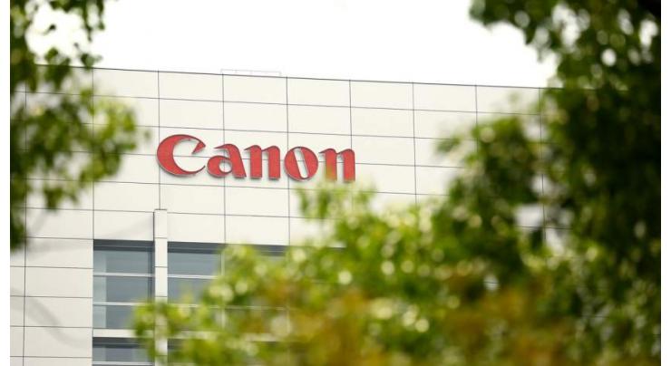 Canon slashes profit forecast on strong yen