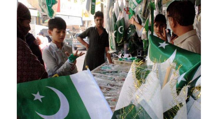 Vendors set up colorful stalls of national flags, banners