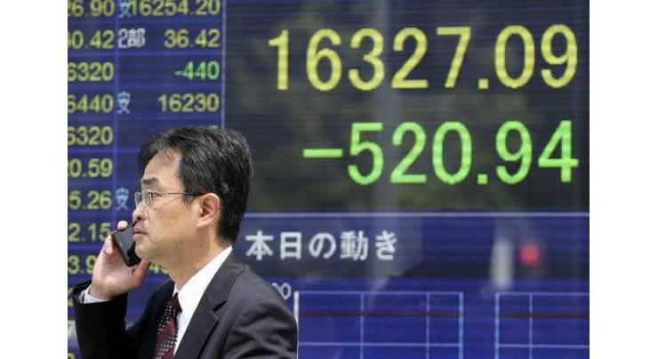 Tokyo shares hit by slide in oil prices