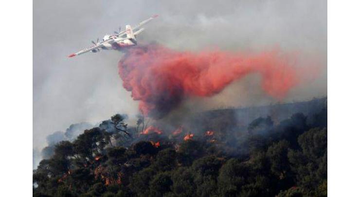 Wildfires tamed in southern France as new blazes feared