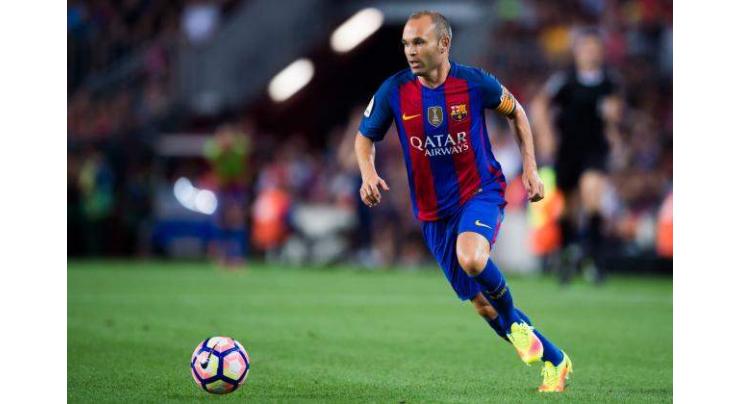 Football: Iniesta out with knee injury