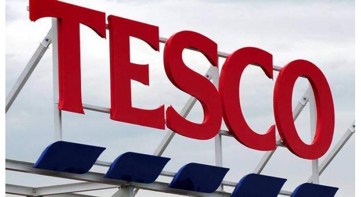 Britain charges three ex-Tesco execs over accounts 
