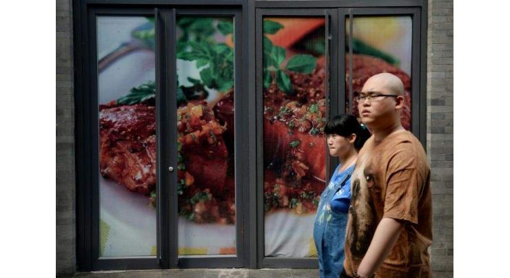 China removes 13-year-old ban on some US beef products 