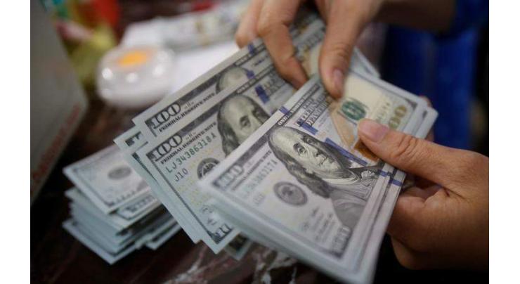 Dollar holds up as traders await Fed rate hike clues 
