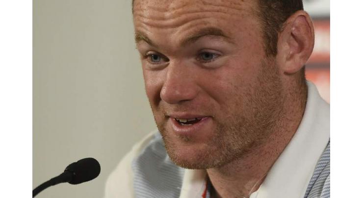 Rooney tired of debate over his best position 