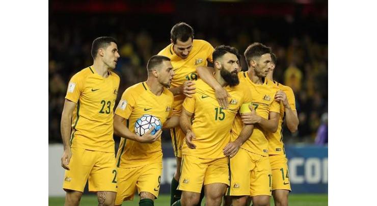 Football: Jedinak penalty earns draw for Australia against Japan 