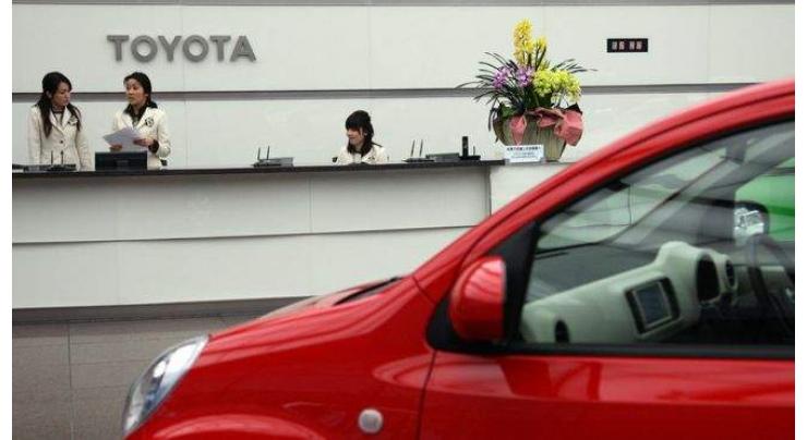 Toyota profit tumbles on strong yen, but lifts full-year view 