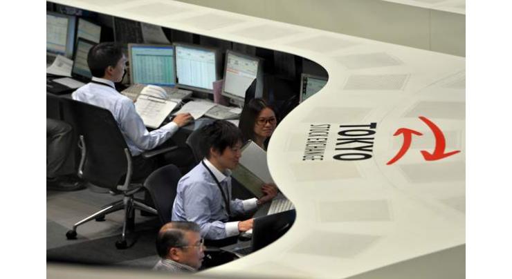 Tokyo stocks edge higher after wild trading 