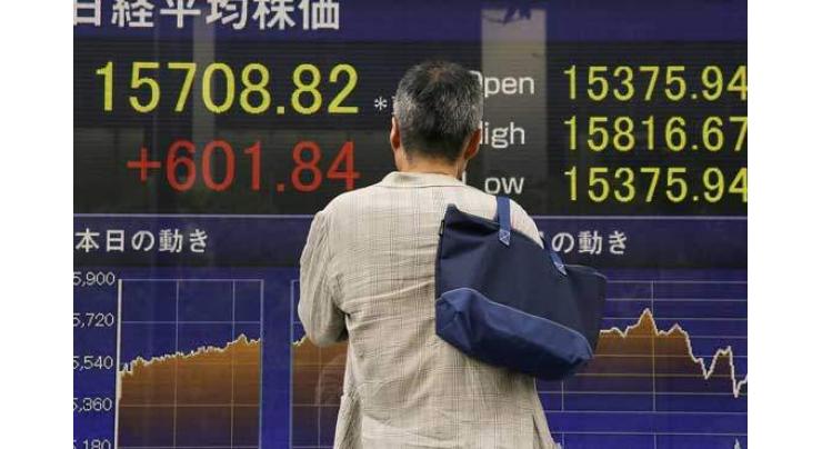 Tokyo shares jump higher on weaker yen 