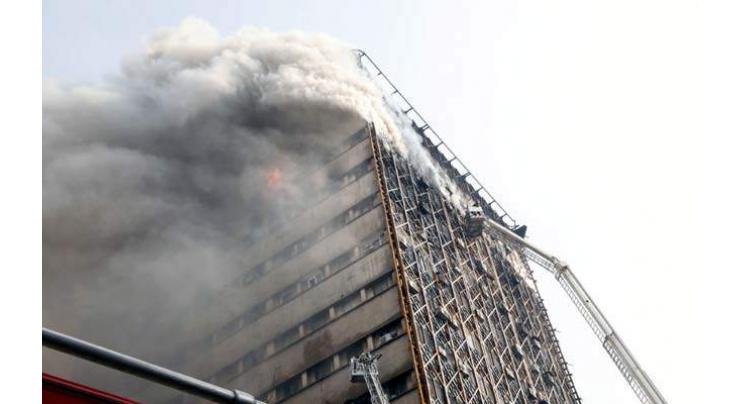 Dozens of Iran firefighters feared trapped in building collapse 