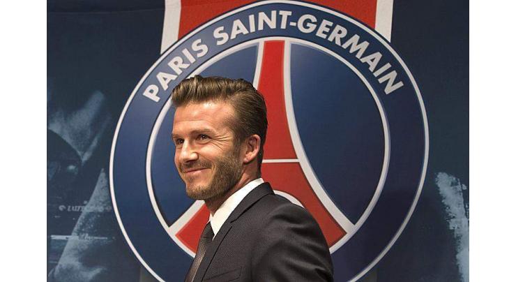 Football: Old boy Beckham drops in on PSG training 