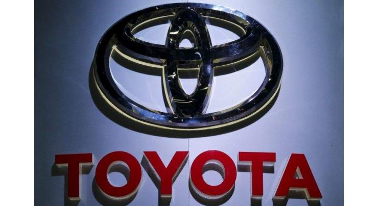 Toyota 9-month net profit falls but hikes annual outlook 