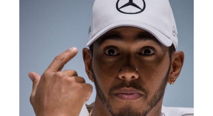 World champion Hamilton dismisses tax 'dodge' row 
