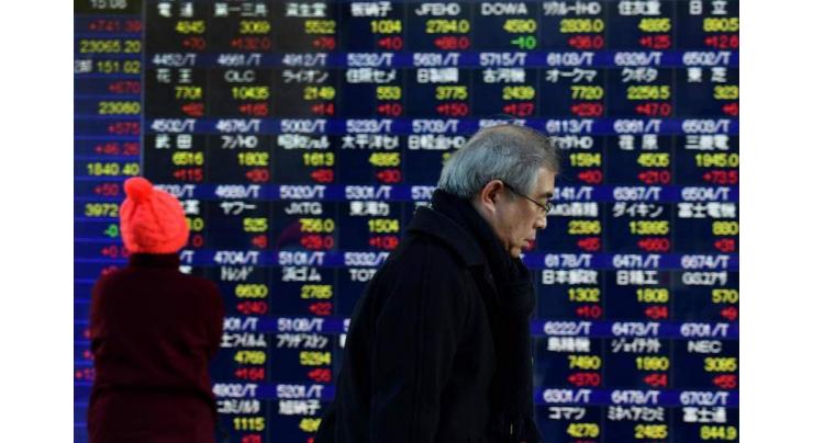 Tokyo stocks close at 26-year high as yen eases 16 January