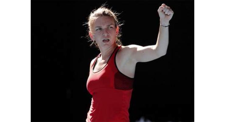 Tennis: Top seed Halep battles into Open second round 