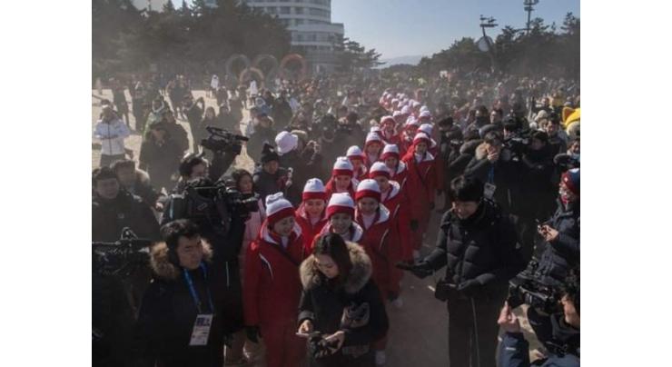 Life's a beach as North Korea cheerleaders mobbed by media 