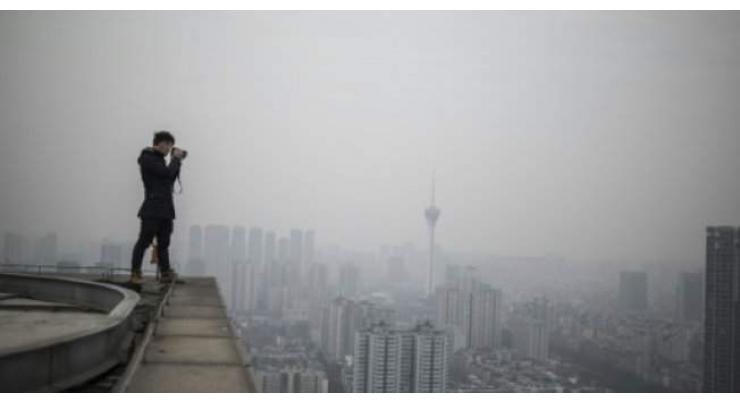 Chinese photographer undeterred by rooftopper's death
