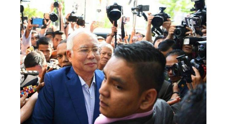 Malaysia's Najib quizzed over scandal, graft fighter reveals threats
