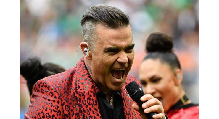 Robbie Williams kicks off World Cup with obscene gesture

