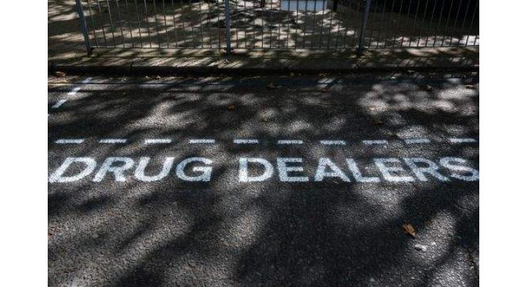 Street artists erect road signs to shame London drug dealers

