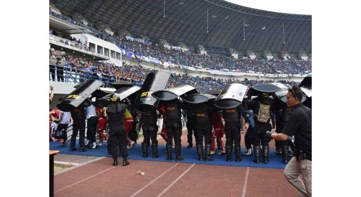 Indonesian football fan beaten to death by rival supporters
