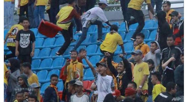 Indonesian football league suspended after deadly fan beating
