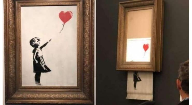 Banksy shocks art world by shredding 1 mn work at auction
