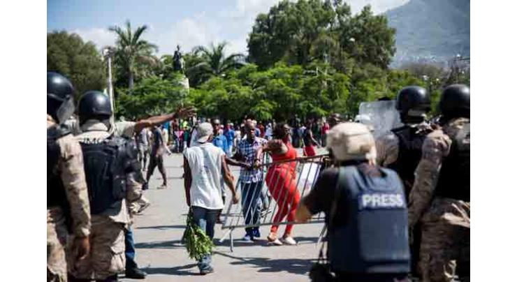 Thousands protest corruption in Haiti, president gets shoved
