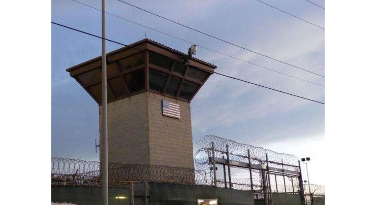 At Guantanamo, prisoners watch parade of US military guards go by
