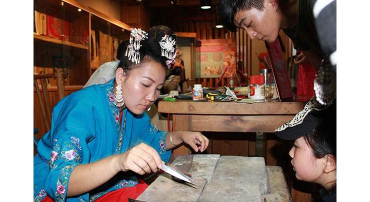 Traditional handicraft booming business breathes life into ethnic Miao village
