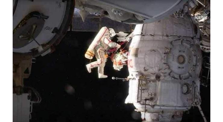 Russian spacewalkers take sample of mystery hole at space station

