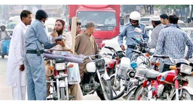 Tractor-trolley driver being provided awareness about rules in Faisalaabd
