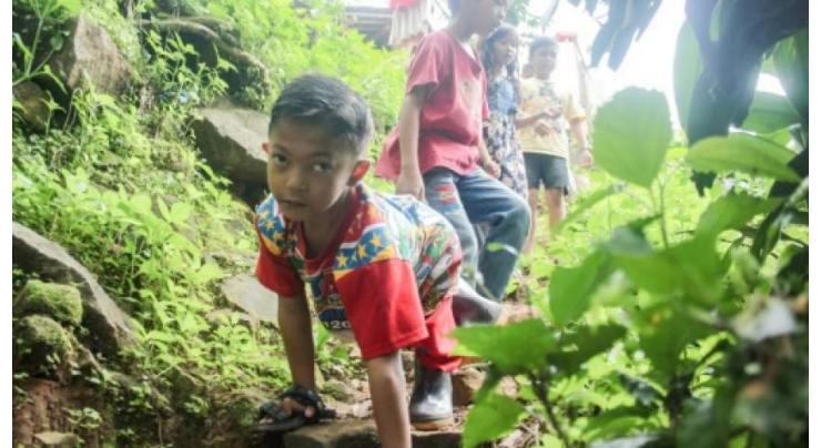 Indonesian third-grader's 'school crawl' becomes sensation
