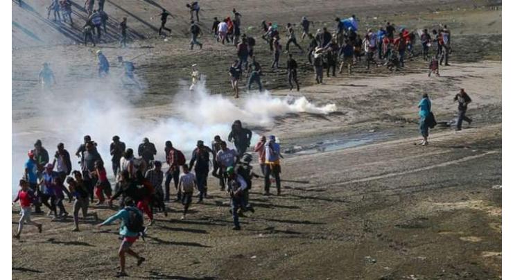 Tear gas fired as dozens of migrants try illegal crossing to US
