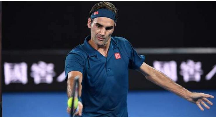 Cool Federer sweeps into Open round two
