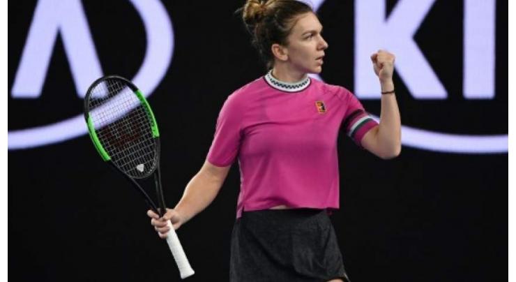 Top seed Halep survives scare to make Open second round

