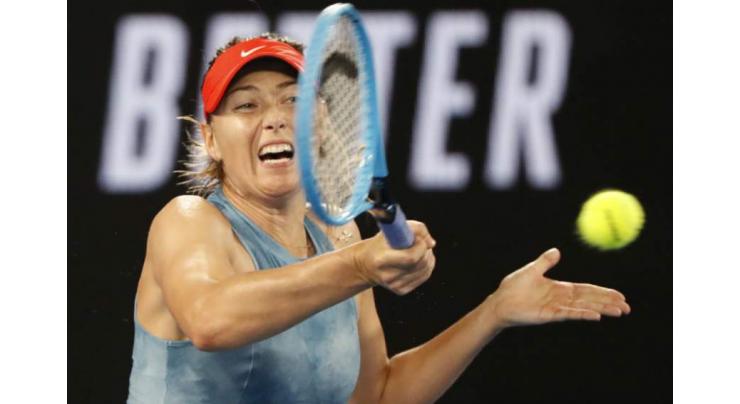 Sharapova stuns Wozniacki as ice man Federer ploughs on
