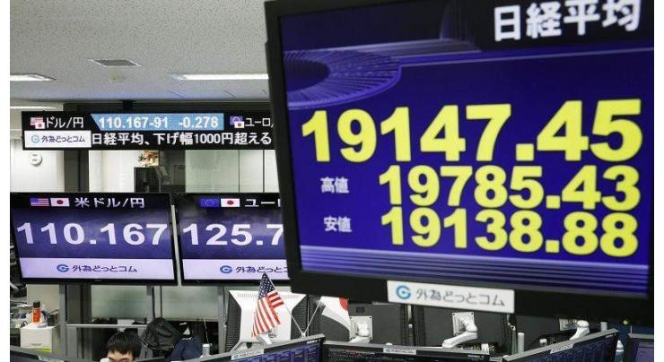Asian markets inch down as trade fears persist
