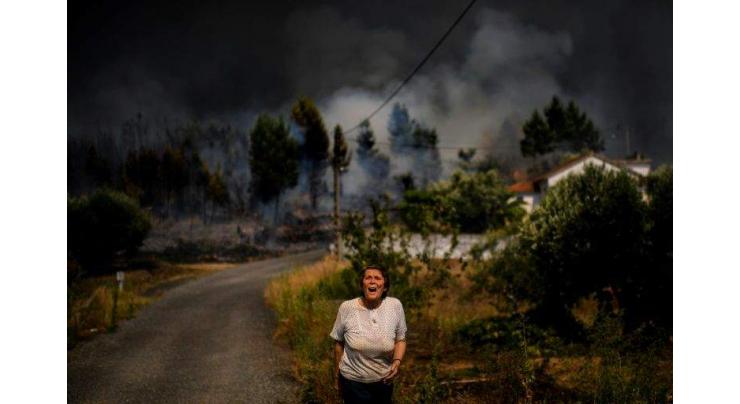 Portugal firefighters control wildfires, but warn of strong winds
