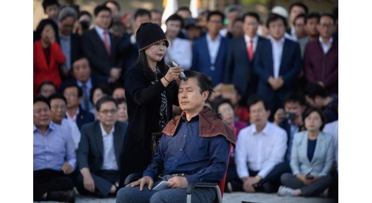South Korea opposition party leader shaves head in protest
