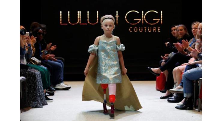 Double amputee girl aged 9 debuts on Paris fashion catwalk
