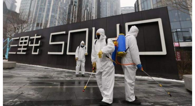 Beijing orders returnees to quarantine as virus death roll hits 1,523
