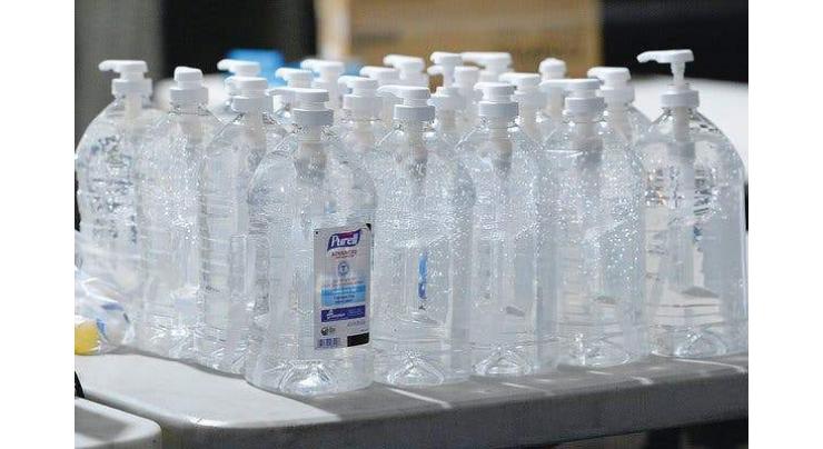 Sindh University management distributes sanitizer bottles among employees
