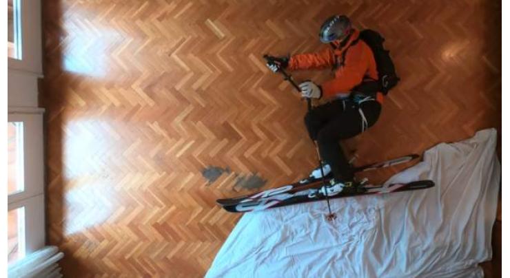 Confined Spaniard stays safe by skiing in his living room
