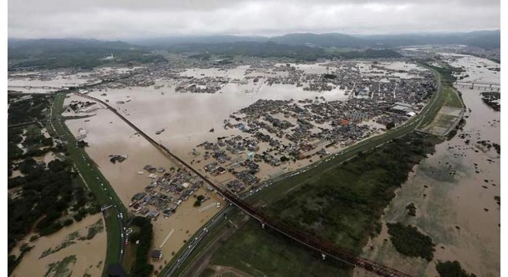 Floods batter Japan as virus cases surge in Tokyo
