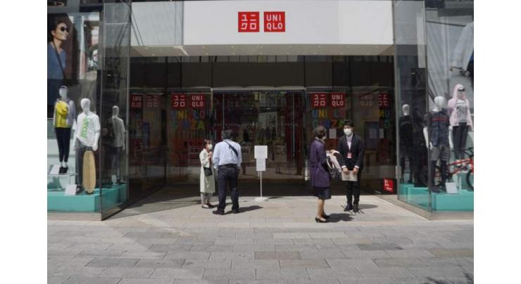 Japan's Uniqlo operator downgrades profit outlook on pandemic
