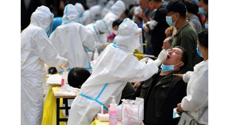 China tests entire city for virus as Europe tightens controls
