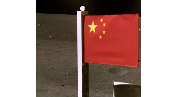 China's space agency releases images of national flag unfurled on moon
