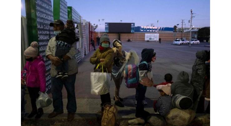 Migrants on US-Mexican border pray Biden opens door
