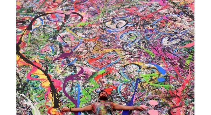 UK artist hopes world's largest art canvas sparks humanitarian movement
